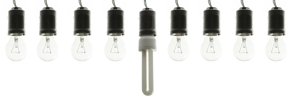 Incandescent light bulbs in a row with energy saving bulb in the middle.