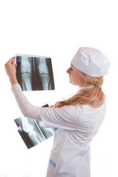 Female doctor examining x-ray isolated on white