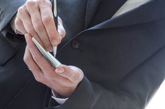 Cropped view of a business man taking notes.