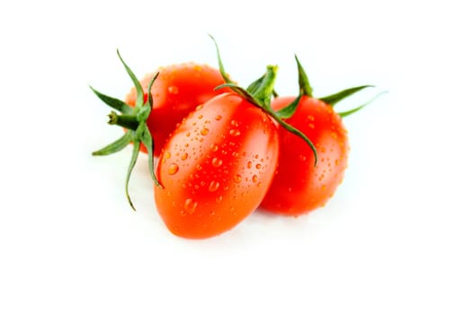 fresh Plum tomatoes with green leaves on white background