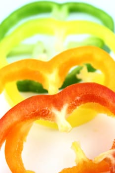 slices of colorful sweet bell pepper on white background