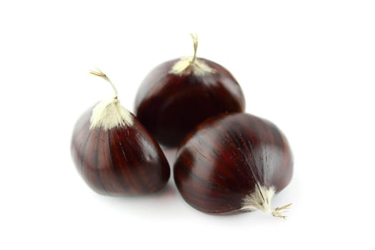 Sweet chestnuts on white background.