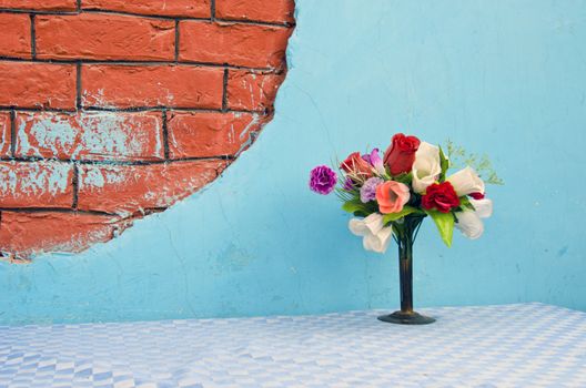 vase with flowers on table in Delhi restaurant, India