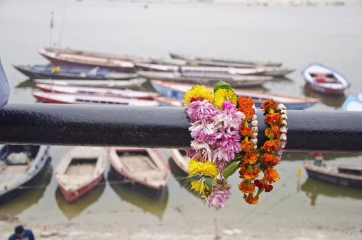 flowers and boats in Varanasi near sacred Ganges river, India