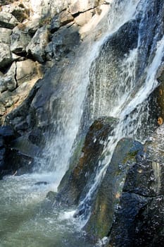 Water streams fall from high mountain