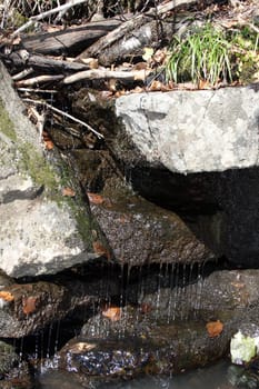 Water streams flow down from the big stones