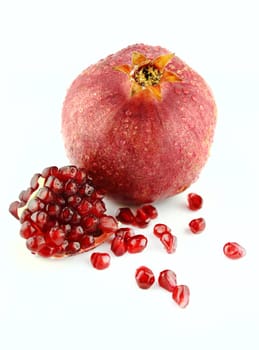 Ripe pomegranate fruit and part isolated on white background .