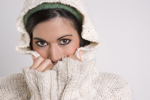 Sensual Attractive Woman Covering Half Her Face with Hands and Sweater