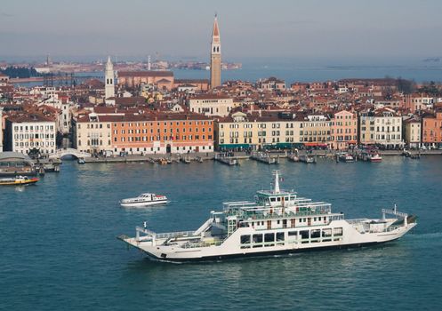 View of Venice in winter sunny day with a ferry boat in the foreground