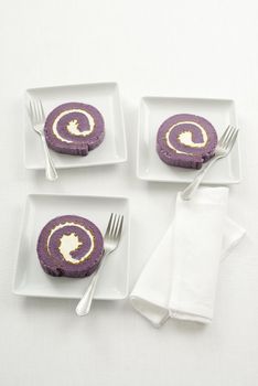 Blueberry roll cake on white plate