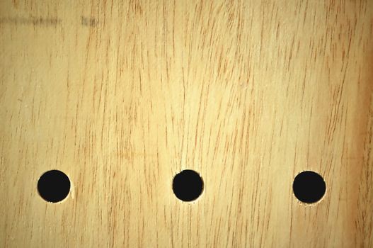 three hole on a wood board