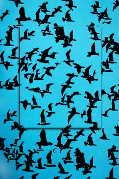 Set of black silhouettes of birds on a blue background