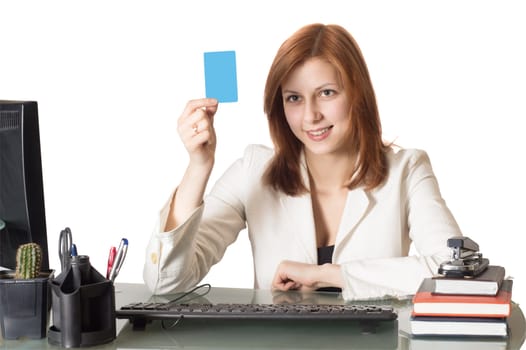 Manager female holding a credit card sitting at a desk in an office on a white background isolated