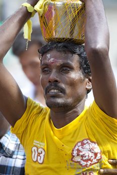 SINGAPORE - JANUARY 27: Male Hindu devotee carrying a kavadi at Thaipusam taken on January 27, 2013 in Singapore. Hindu festival to worship God Muruga.