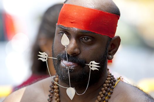 SINGAPORE - JANUARY 27: Male Hindu devotee carrying a kavadi at Thaipusam taken on January 27, 2013 in Singapore. Hindu festival to worship God Muruga.