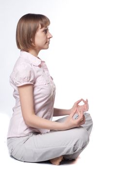 young girl meditates in office clothes