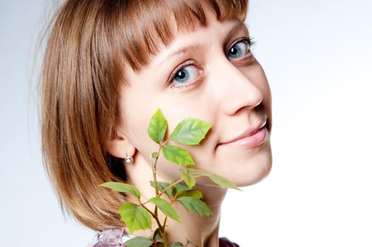 young girl with a plant in the face
