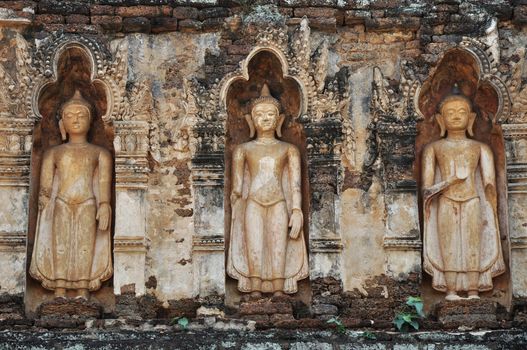 Standing Buddha on chedi 'Suwan Chang Kot' of Wat Ku Kut (Wat Jam Thewee), Lamphun Thailand