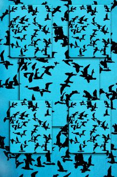 Set of black silhouettes of birds on a blue background