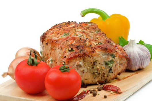 Roasted Loin Pork and Various Vegetables with Parsley, Tomato , Garlic, Onions, Bell Pepper and Spices closeup on Cutting Board