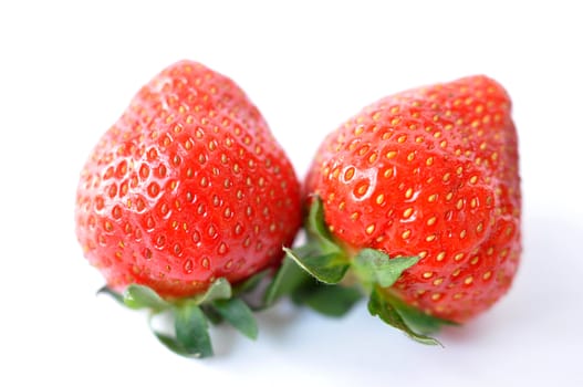 Red strawberry fruits on a white background