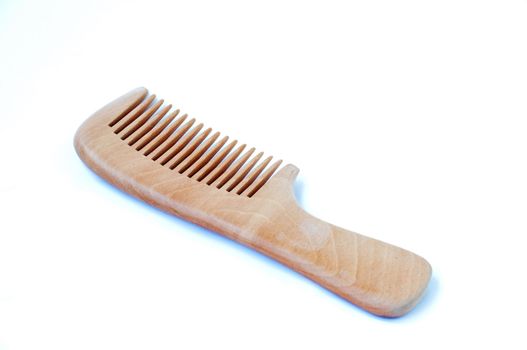 Wooden comb on a white background