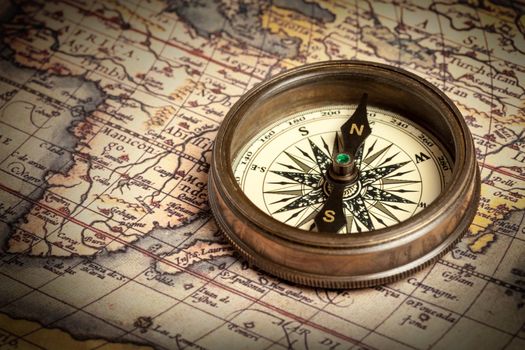 Old vintage retro compass on ancient map