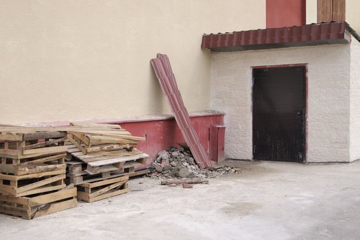 debris near the building, asphalt soiled cement dust