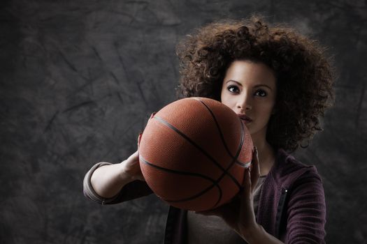 Closeup of young woman shooting a basketball