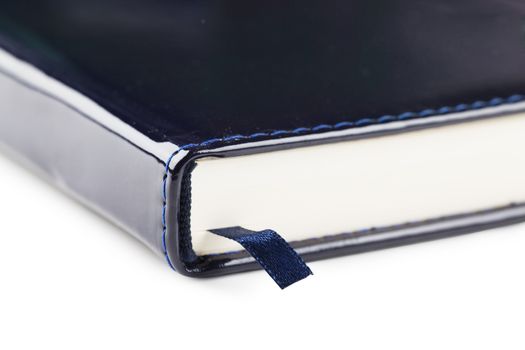 Closeup view of bookmark in a blue organizer over white background