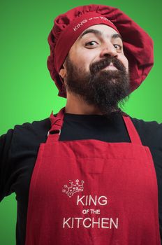 happy bearded chubby chef on green background