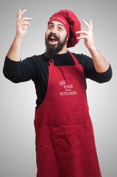 happy bearded chubby chef on gray background