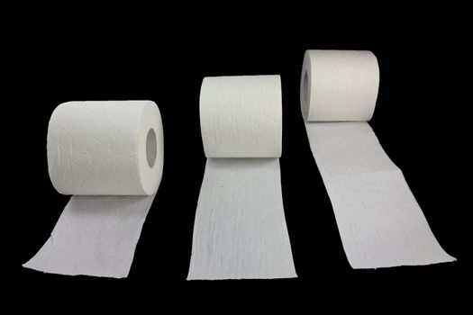 Picture of three toilet rolls racing on a black background