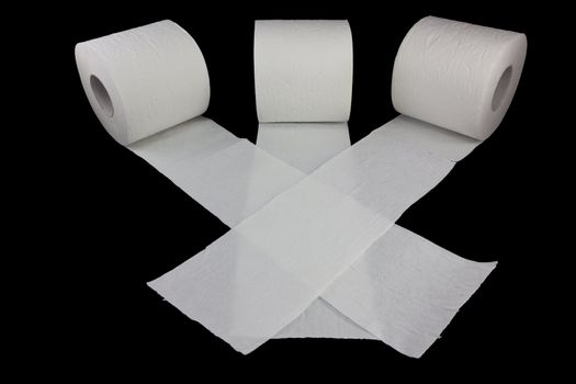 Picture of three toilet rolls racing on a black background