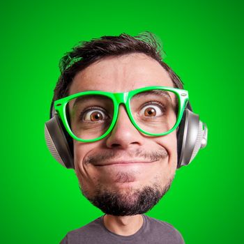 puppet man listening to music with big head on green background