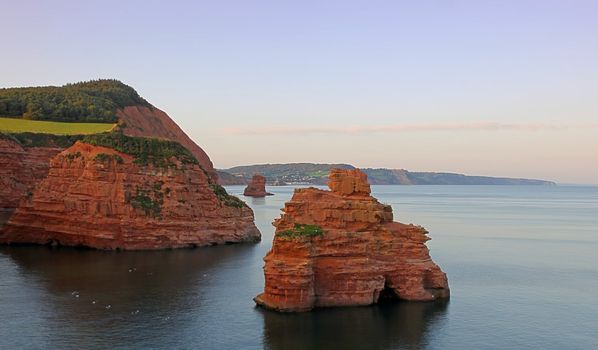 Twilight views of the beach and sea stacks at Ladram Bay, Devon