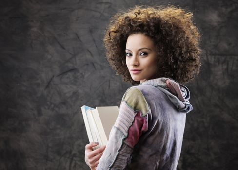Portrait of beautiful girl student with books