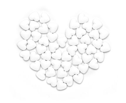 White pills form heart shape isolated on grey background