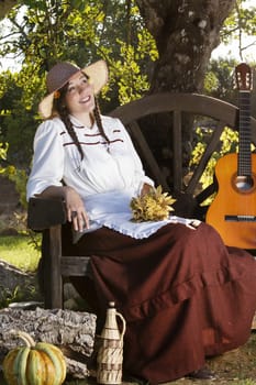 View of a beautiful girl in a classic dress in a countryside set.