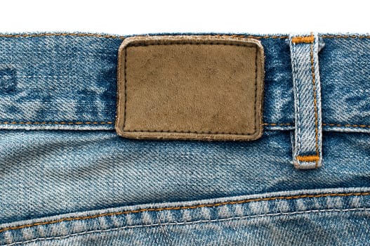 Blank leather jeans label sewed on a blue jeans