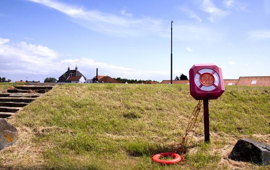 Molested life-buoy along a dike