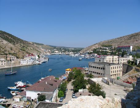 seafront with ships at pier Balaclava Town, Crimea, Ukraine