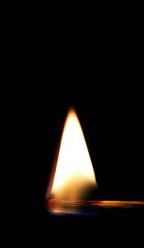 Burning match on a black background