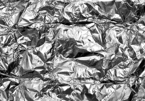 Abstract crumpled silver aluminum foil closeup