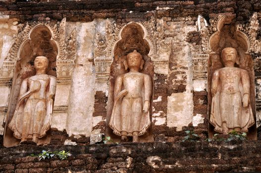 Standing Buddha on chedi 'Suwan Chang Kot' of Wat Ku Kut (Wat Jam Thewee), Lamphun Thailand