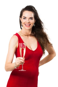 A beautiful happy woman wearing a red dress holding a glass of Champagne and looking at camera. Isolated on white.