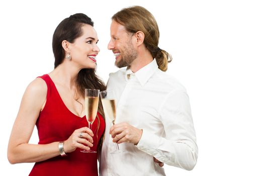 A happy couple in love looking at eachother while doing cheers with Champagne. Isolated on white.