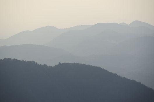 Mountains with fog forest and sunshine 