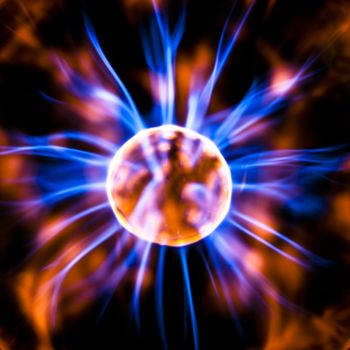 The middle of a plasma orb radiates colored light currents