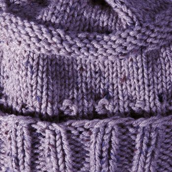 Close up of handmade knit hat made of purple yarn